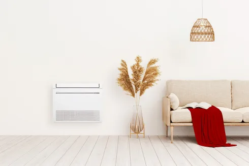 Console de climatisation Mitsubishi Electric posée au sol dans un salon : la solution qui chauffe par le bas, installée par Kozéo